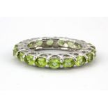 A 925 silver oval cut peridot full eternity ring, (O).