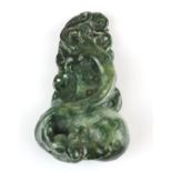 A finely carved Chinese green jadeite jade amulet of a dragon with a peach and cash, H. 6cm.
