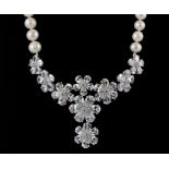 A single strand necklace of 8.5mm cultured pearls with a central crystal set panel, L. 52cm.