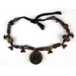 A re-strung Tibetan necklace of sacred pilgrimage objects, flower Dia. 5cm.