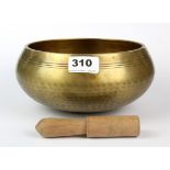 A Tibetan hammered bronze singing bowl with wooden hammer, Dia. 21cm D. 9cm.