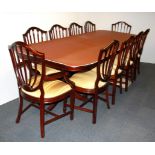 A large contemporary extending mahogany dining table and ten chairs with full size heat protector,