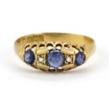 An 18ct yellow gold ring set with sapphires and diamonds, (M.5).