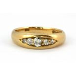 An 18ct yellow gold ring set with five old cut graduated diamonds, (M).