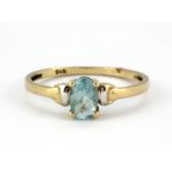 A 9ct yellow gold ring set with an oval cut blue topaz, (M).