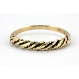 A 9ct yellow gold rope set ring, (P.5).