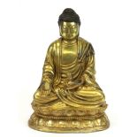 A Sino-Tibetan gilt bronze figure of the seated Buddha, H. 17cm.