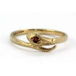 A 9ct yellow gold garnet set snake shaped ring, (I.5).