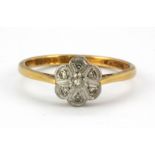An 18ct yellow and white gold diamond set cluster ring, (Q.5).
