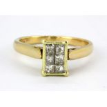 An 18ct yellow gold ring set with princess cut diamonds, (O).