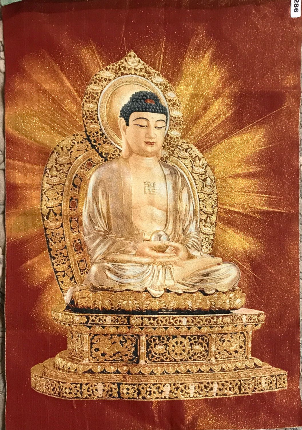 A Chinese woven silk panel of the seated Buddha with gilt thread, size 61 x 90cm.