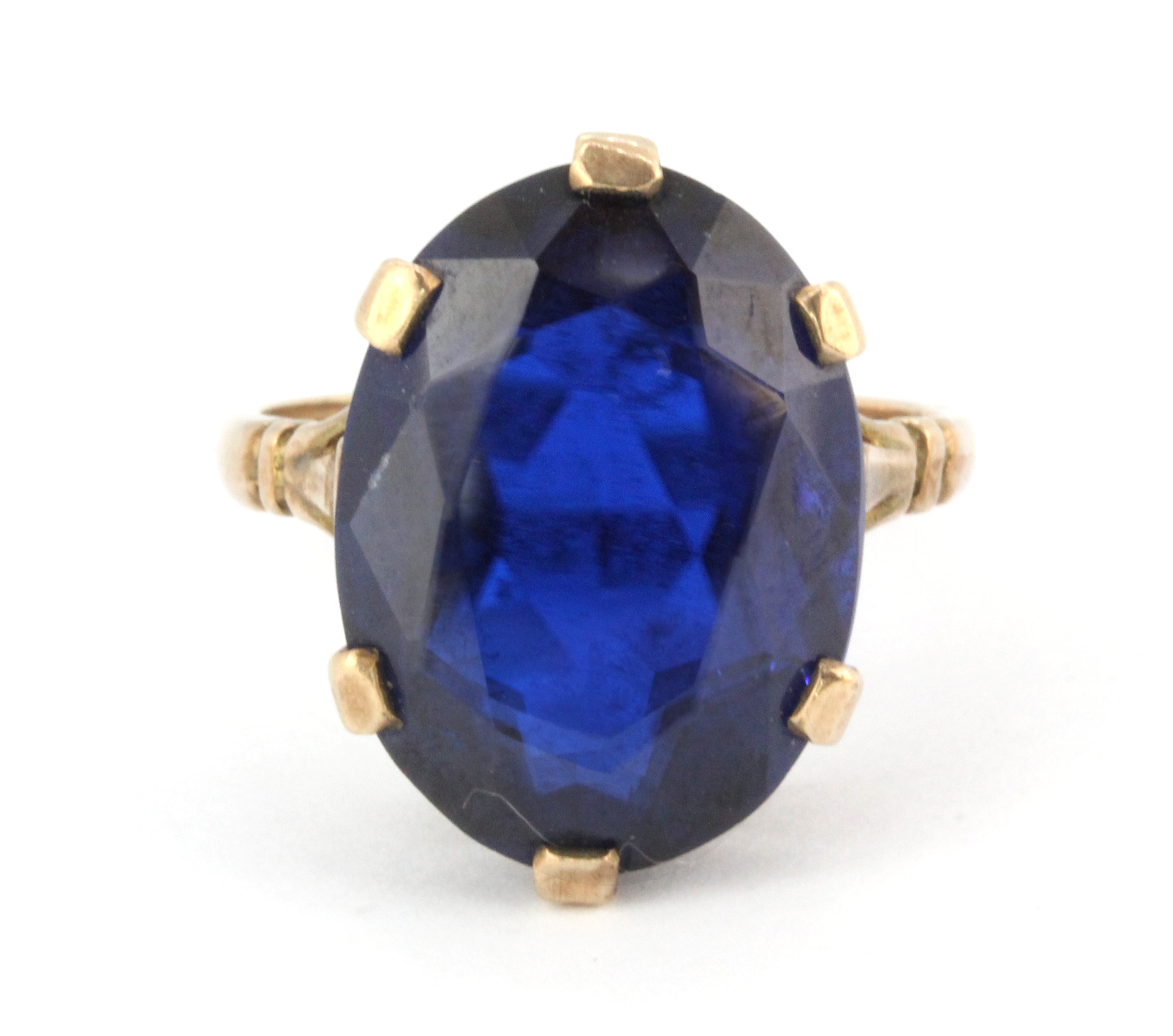 A 9ct yellow gold ring set with a large oval cut blue stone, (P).