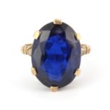A 9ct yellow gold ring set with a large oval cut blue stone, (P).