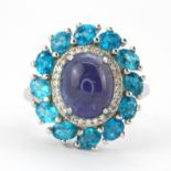 A 925 silver ring set with cabochon cut tanzanite and apatites, (Q.5).