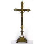 An early 20th Century continental gilt brass crucifix, H. 57cm.
