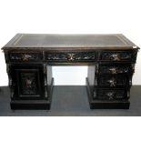A 19th century leather topped carved oak desk, size 138 x 59 x 78cm.