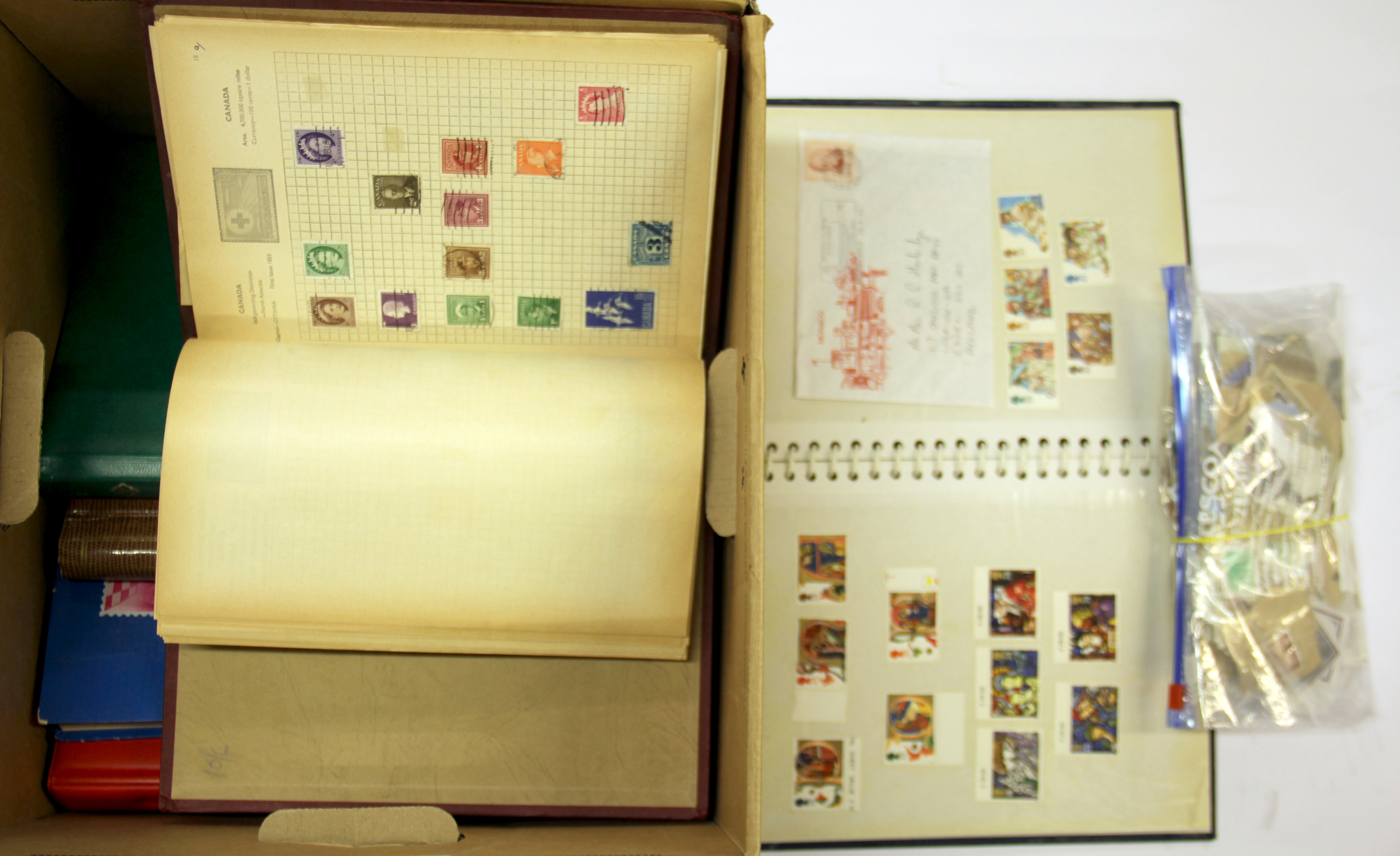 A box of mixed stamps and stamp albums.