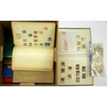 A box of mixed stamps and stamp albums.