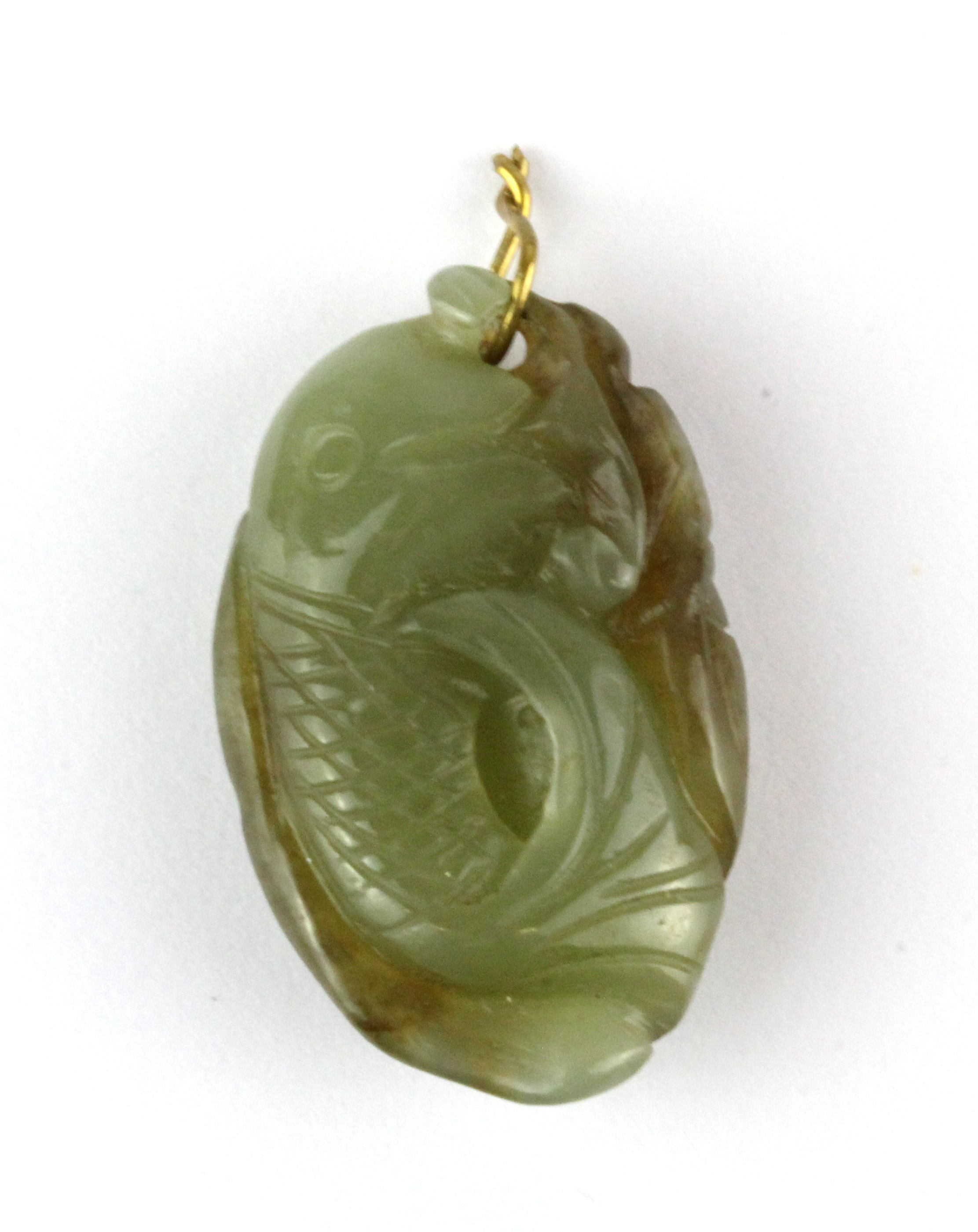 A small antique Chinese carved nephrite jade amulet of a fan tailed fish, H. 3cm.