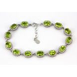 A 925 silver bracelet set with round and pear cut peridot and white stones, L. 21cm.