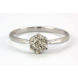 A 9ct white gold diamond set cluster ring, (N.5).