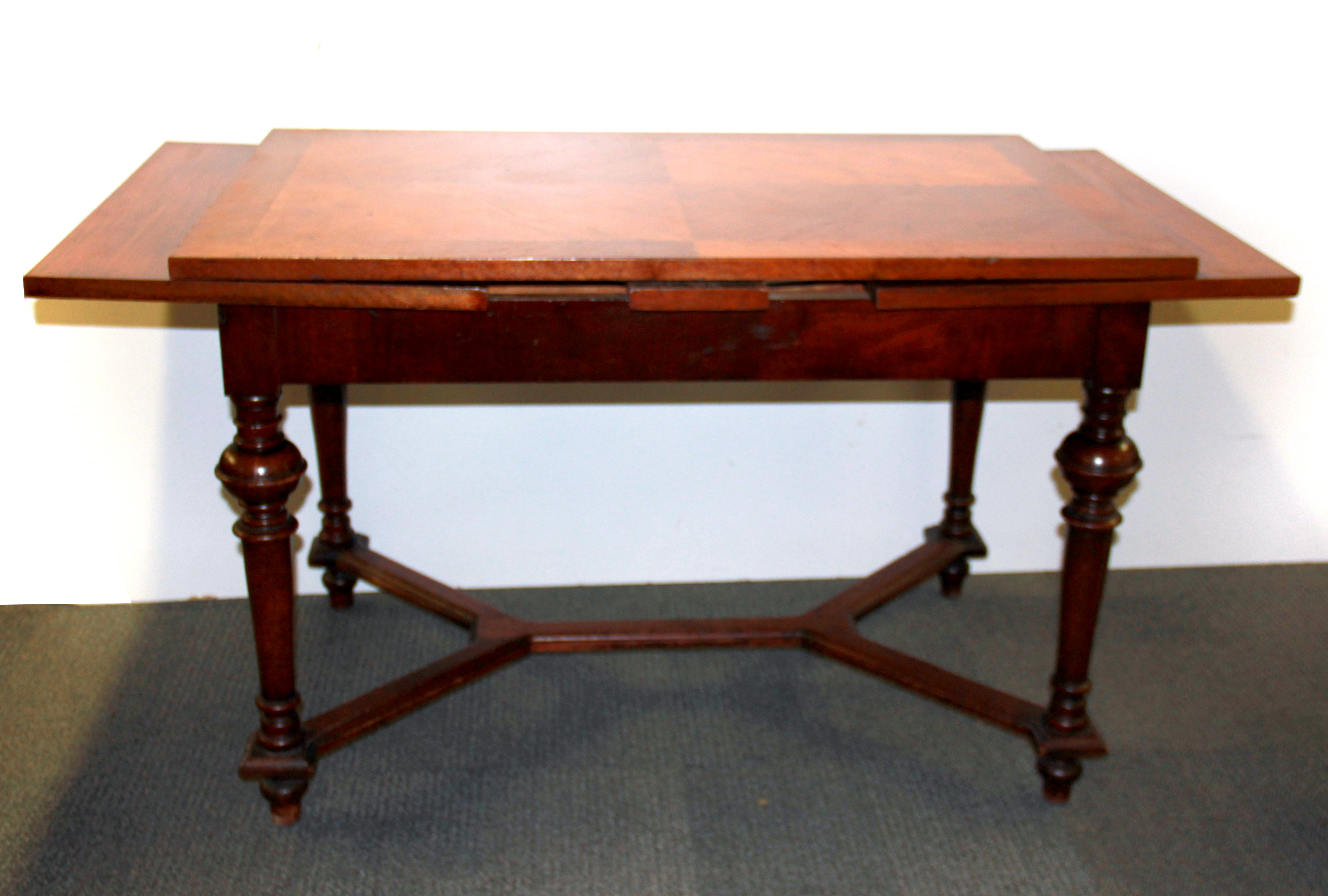 An unusual mahogany drawleaf refectory style dining table, W. 75cm L. 170cm opening to 140cm.