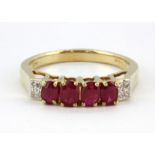 A 9ct yellow gold ring set with four oval cut rubies and diamond set shoulders, (L).
