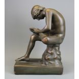 A bronze finished plaster figure of the boy with the thorn in his foot, H. 35cm.