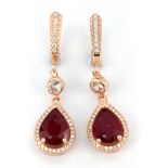 A pair of 925 silver rose gold gilt drop earrings set with pear cut rubies and white stones, L. 3.
