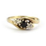 A 9ct yellow gold sapphire and diamond set crossover ring, (N.5).