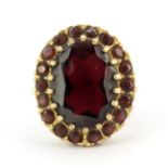 A large 9ct yellow gold garnet set cluster ring, (U).