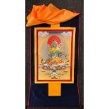 A Tibetan printed thangka of the green Tara mounted on a silk scroll, size 82 x 126cm.
