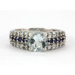 A 9ct white gold ring set with blue topaz and sapphires, (O).