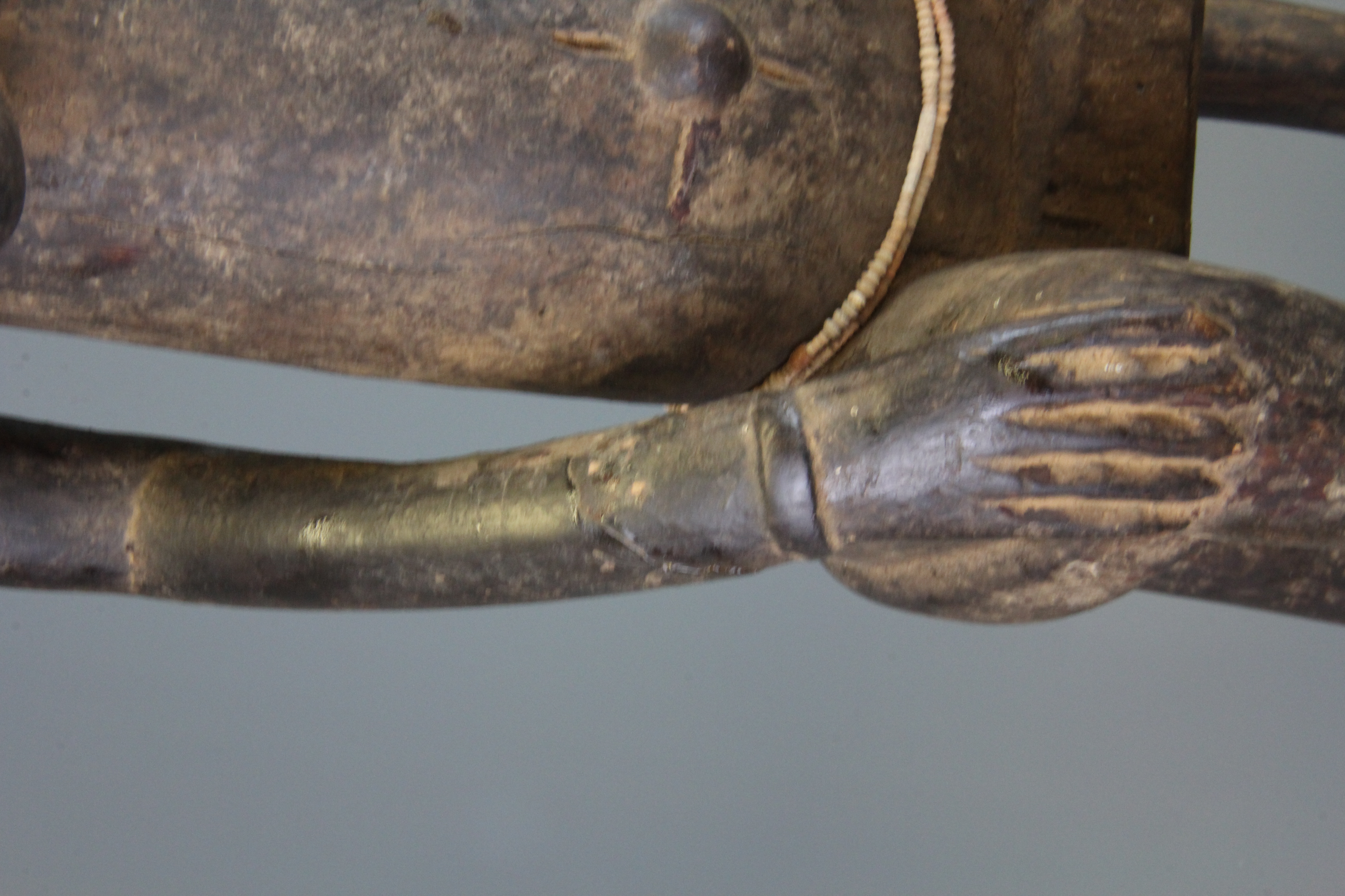 A tall African Punu tribal carved wooden figure of a woman sitting on a stool, H. 78cm. - Image 2 of 2