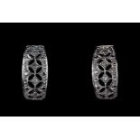 A pair of 9ct white gold diamond set earrings, L. 1.2cm.