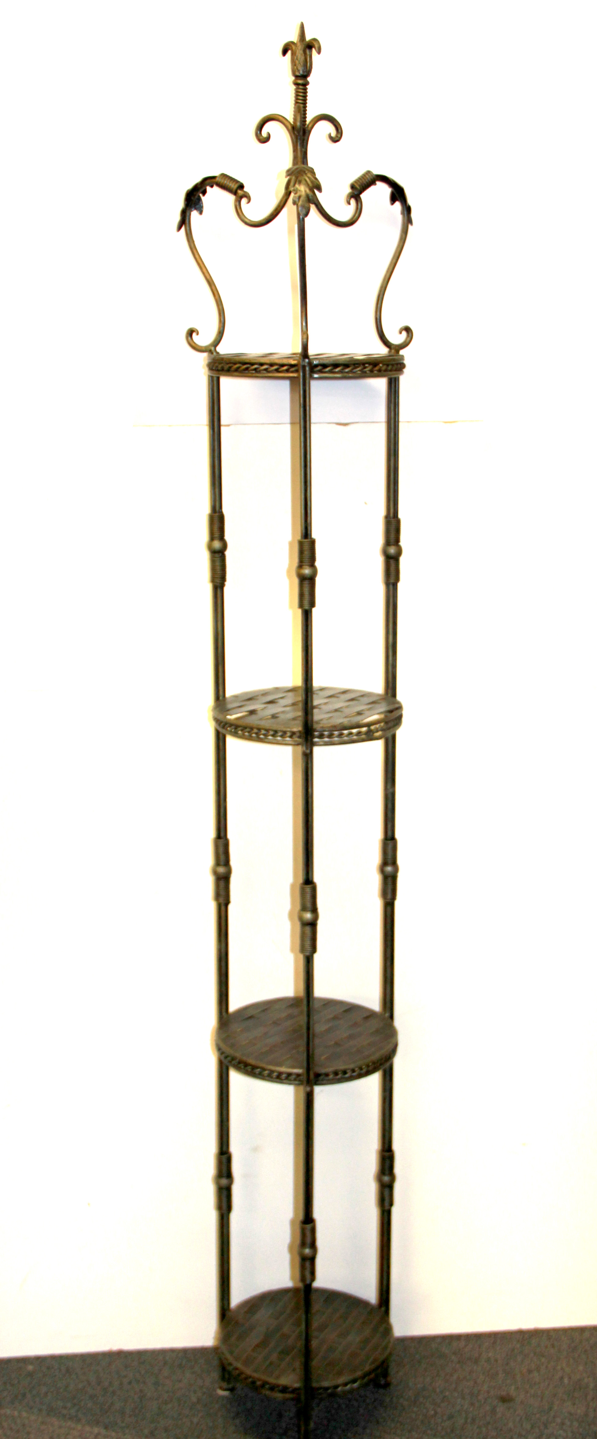 A wrought metal plant stand, H. 166cm.