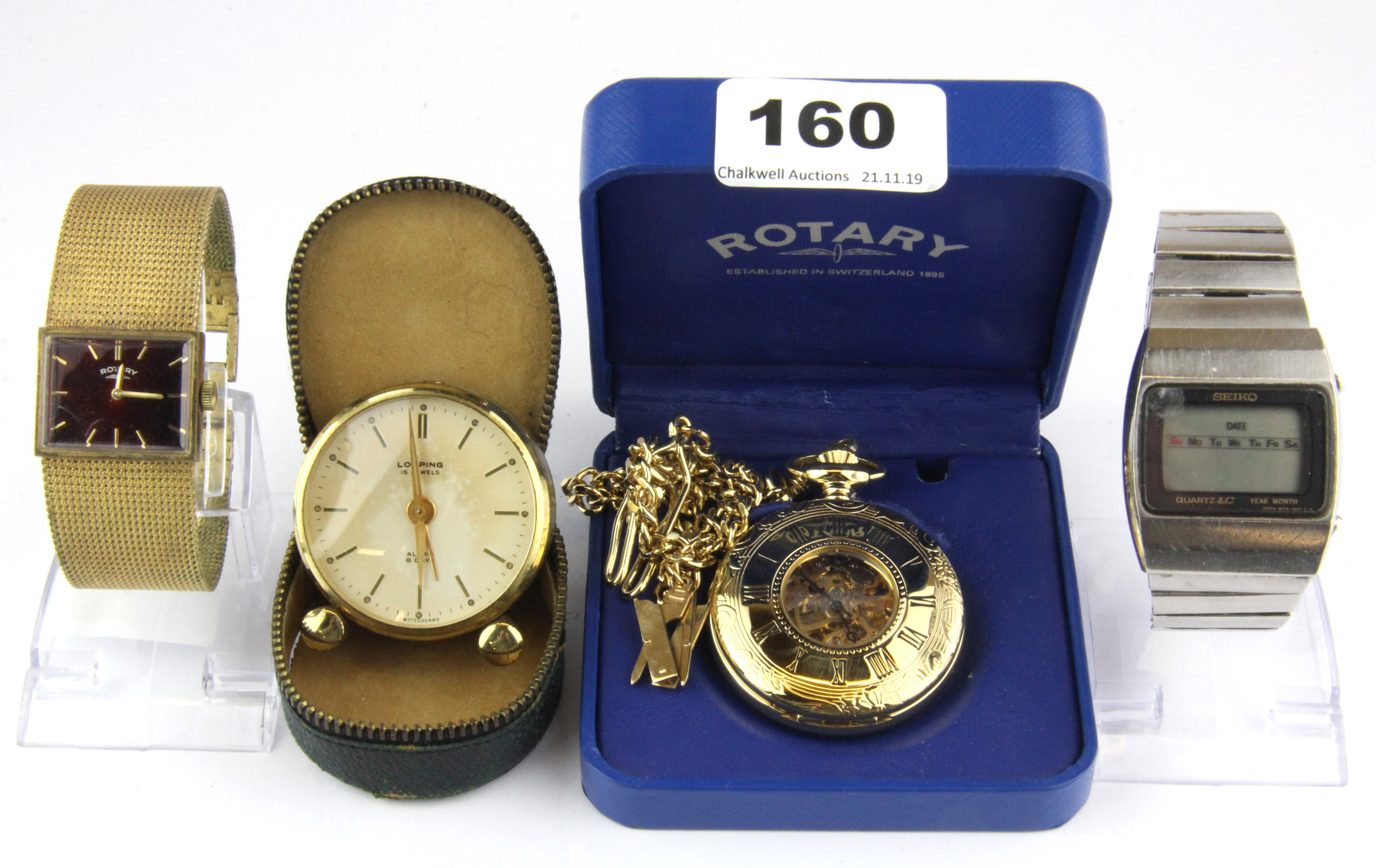 A gilt pocket watch, a cased alarm clock and two vintage gentleman's wrist watches.