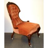 A Victorian walnut nursing chair.