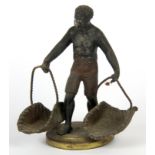 A cold painted metal figure of a negro trader carrying two baskets, H. 12cm.