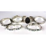 A quantity of four mixed silver bangles and bracelets.