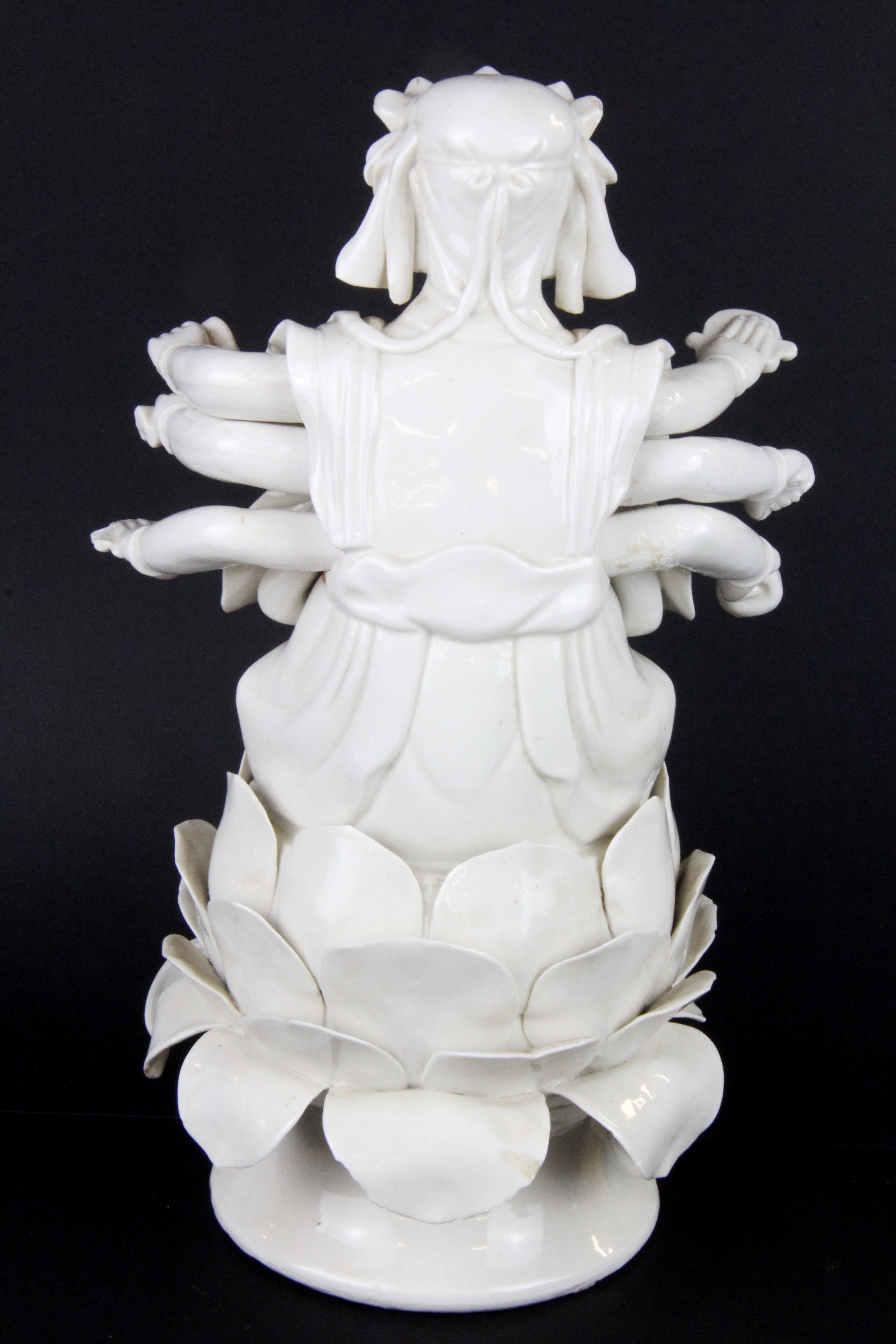 An early 20thC Tibetan blanc de chine glazed ceramic figure of a multi armed deity, H. 26cm. - Image 2 of 4