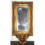 A gilt framed wall mirror with shelf, H. 65cm W. 33cm.