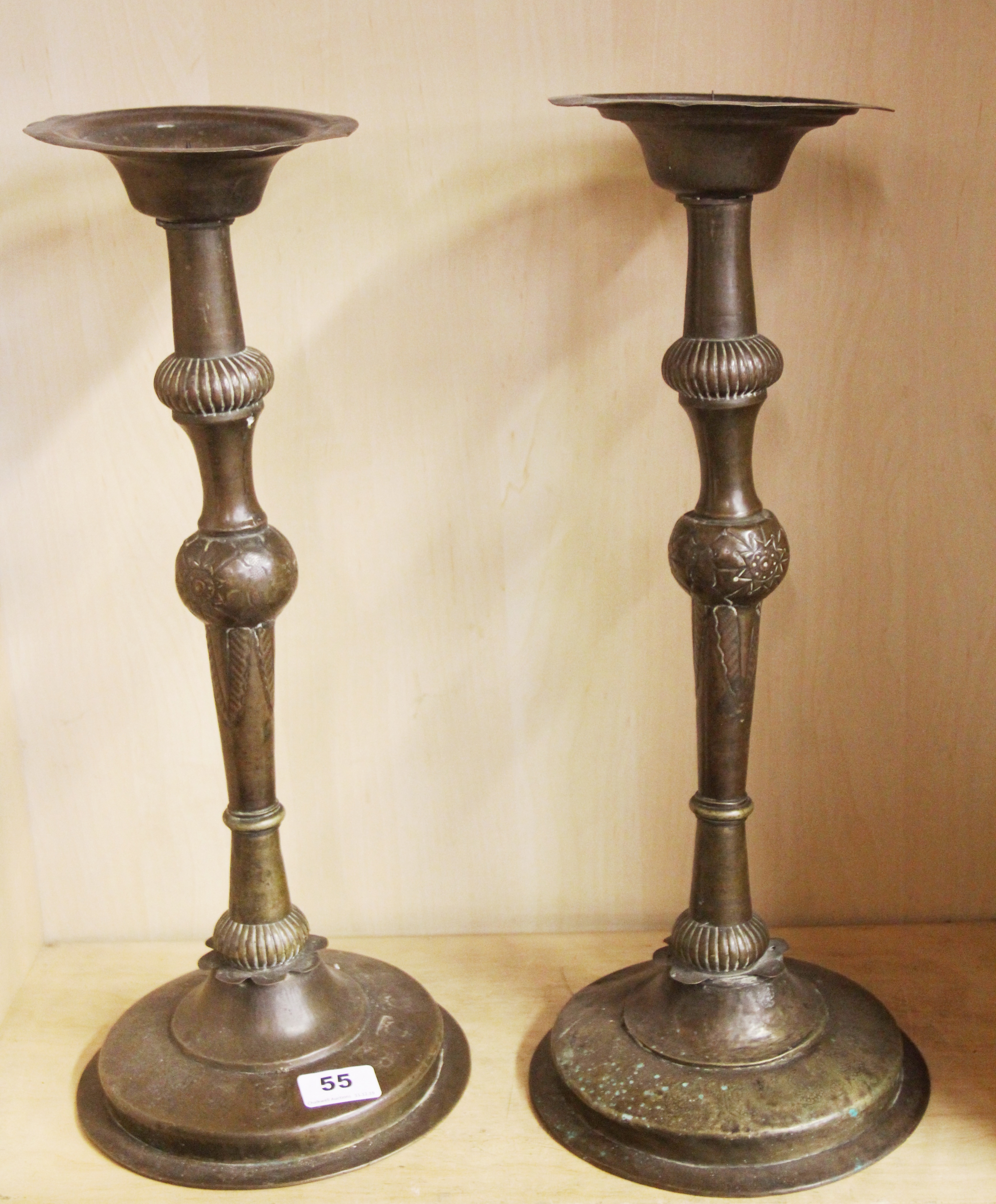 A pair of 19th Century hammered Eastern brass candlesticks, H. 48cm.