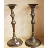 A pair of 19th Century hammered Eastern brass candlesticks, H. 48cm.