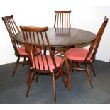 An Ercol dropleaf table and four chairs together with an Ercol trolley.