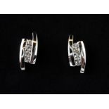 A pair of 18ct white gold stud earrings set with four brilliant cut diamonds, L. 1.2cm.