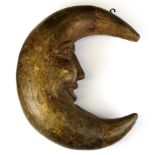 A late 19th Century carved wooden hanging moon figure, size 40 x 32cm.