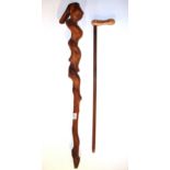 A large twisted wooden walking stick together with a metal peanut handled '19 Jimmy Carter 76'