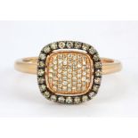 A 14ct rose gold (stamped 14k) diamond set halo ring, (Q).