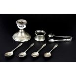 A hallmarked silver candlestick, silver napkin ring with four silver coffee spoons and sugar tongs.